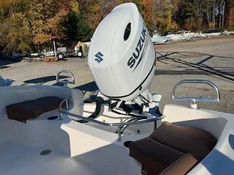 Slide: The Image of 2024 Pioneer 202 Sportfish boat with tan and white seating, steering wheel, and Suzuki outboard motor. - 3
