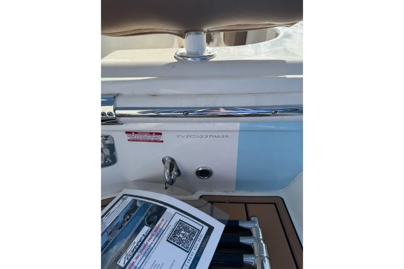 Slide: The Image of 2026 Pioneer 202 Sportfish boat interior with chrome details and informational brochure. - 6