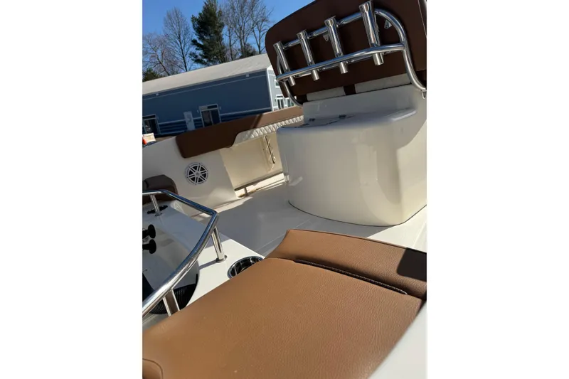 Slide: The Image of 2026 Pioneer 202 Sportfish boat interior with brown seating and stainless steel fixtures. - 7