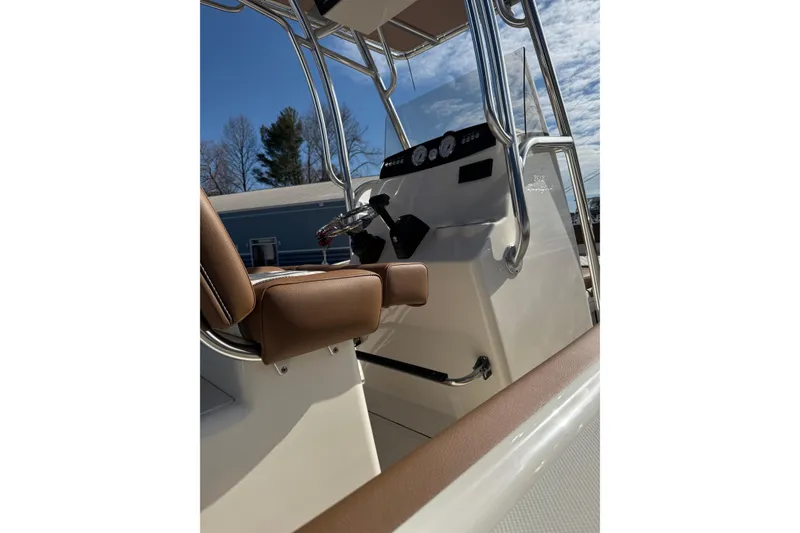 Slide: The Image of 2026 Pioneer 202 Sportfish boat interior with steering console and seating. - 9