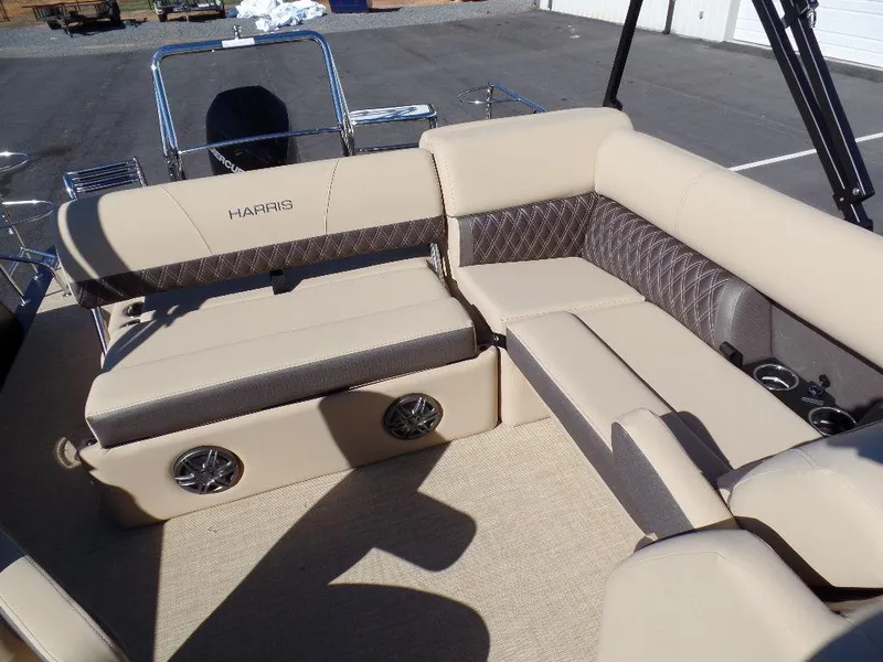 Slide: The Image of 2024 Harris Sunliner 250 boat interior with beige and brown seating. - 12
