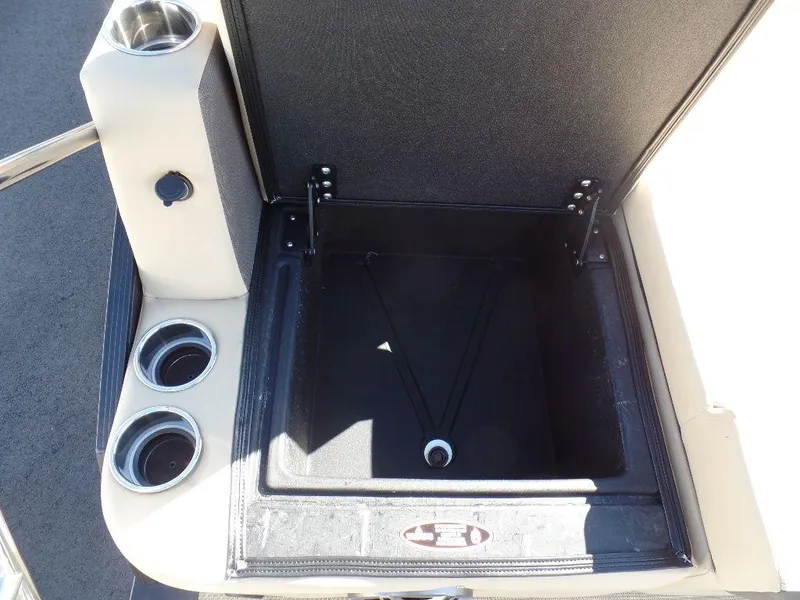 Slide: The Image of Open storage compartment on 2024 Harris Sunliner 250 boat with cup holders. - 13