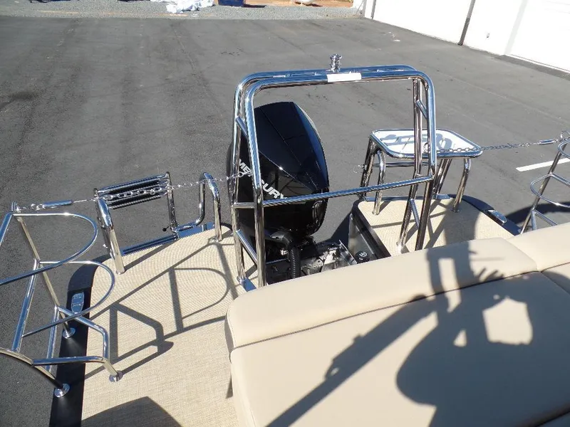 Slide: The Image of 2024 Harris Sunliner 250 boat rear view with engine and seating. - 16