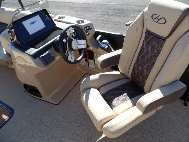 Slide: The Image of 2024 Harris Sunliner 250 boat interior with captain's chair and steering console. - 5