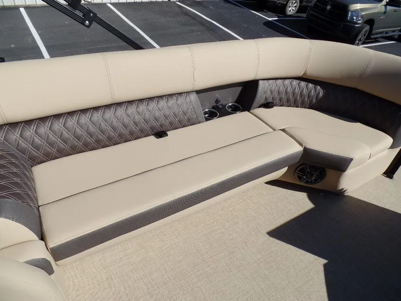 Slide: The Image of 2024 Harris Sunliner 250 boat interior with beige and gray cushioned seating. - 7