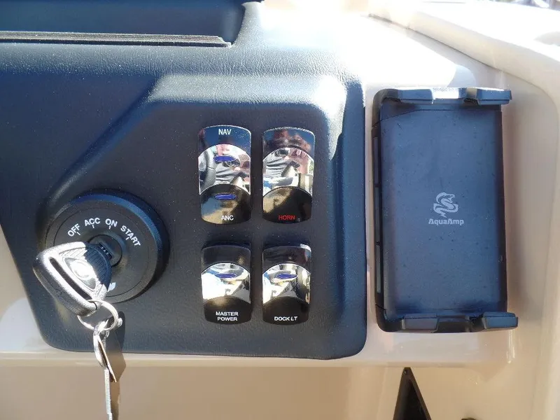 Slide: The Image of Control panel of 2024 Harris Sunliner 250 boat with ignition and switches. - 9