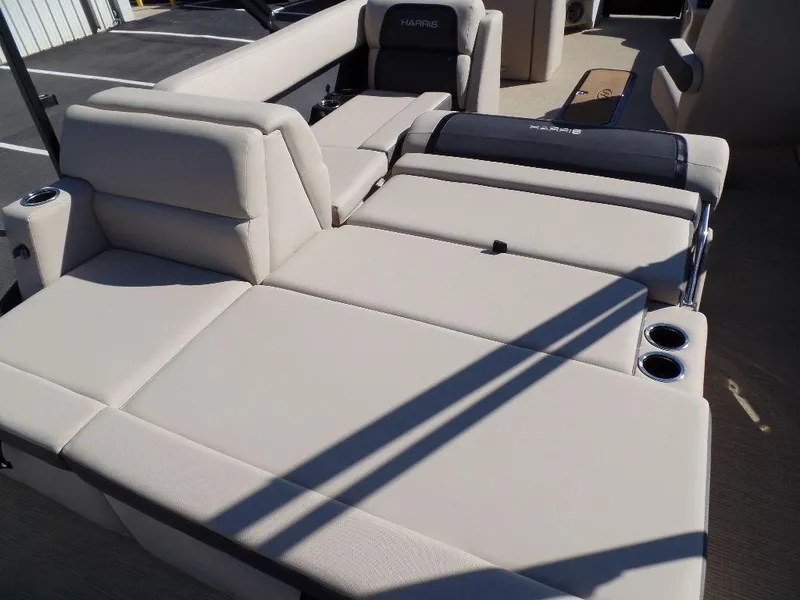 Slide: The Image of 2024 Harris Cruiser 230 boat with beige seating and cup holders. - 13