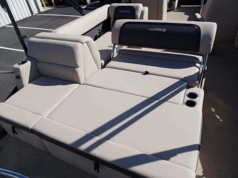Slide: The Image of 2024 Harris Cruiser 230 boat interior with beige seating and cup holders. - 14