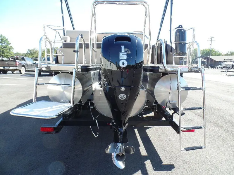 Slide: The Image of 2024 Harris Cruiser 230 pontoon boat rear view with 150 HP outboard motor. - 2