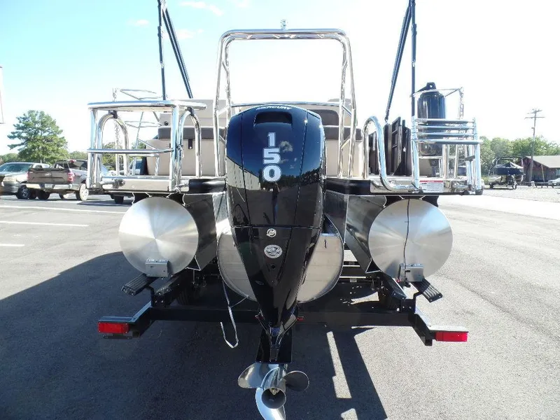 Slide: The Image of 2024 Harris Cruiser 230 pontoon boat with a 150 HP outboard motor, rear view. - 3