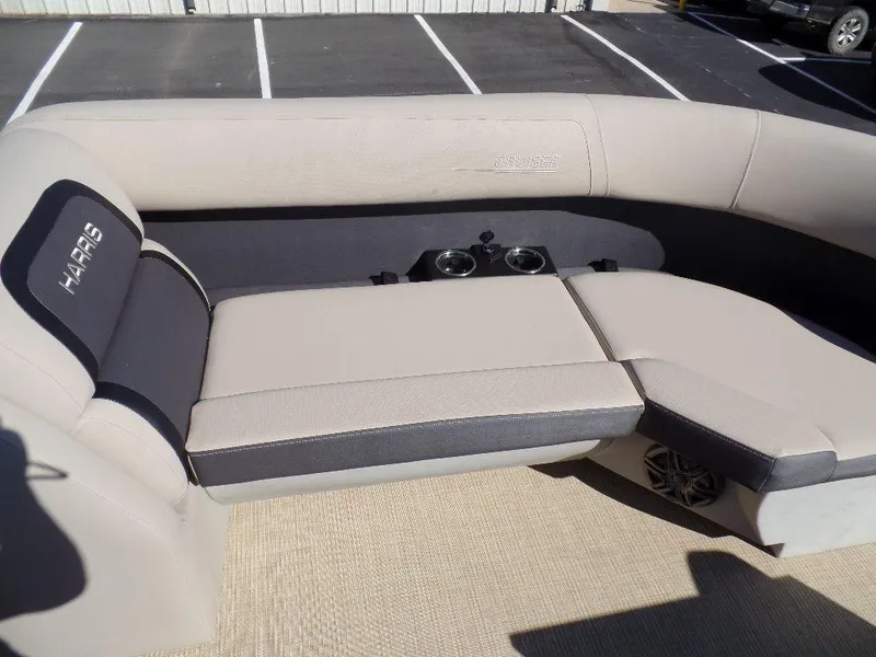Slide: The Image of 2024 Harris Cruiser 230 boat interior with beige seating and cup holders. - 4