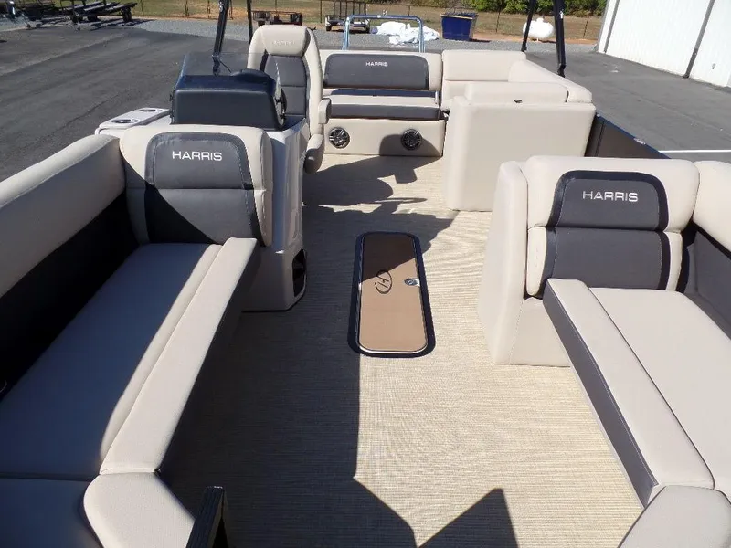 Slide: The Image of 2024 Harris Cruiser 230 pontoon boat interior with beige and gray seating. - 6