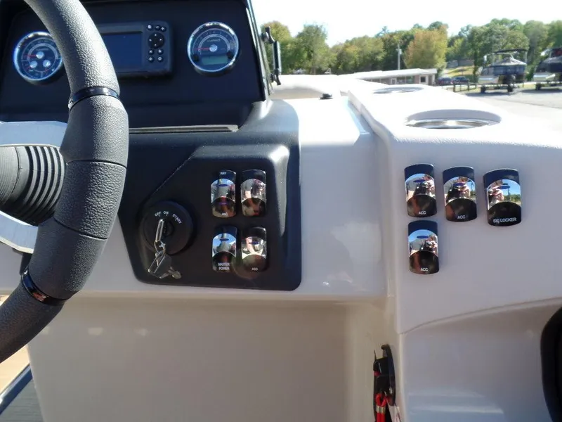 Slide: The Image of Control panel of 2024 Harris Cruiser 230 boat with steering wheel and switches. - 8