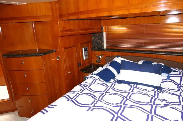Slide: The Image of Luxurious bedroom in 2001 Carver 530 Voyager Pilothouse yacht with wooden cabinetry. - 13