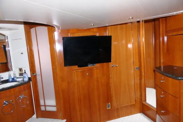 Slide: The Image of 2001 Carver 530 Voyager Pilothouse interior with TV and wooden cabinetry. - 14