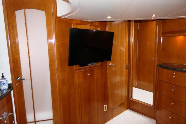 Slide: The Image of Interior of 2001 Carver 530 Voyager Pilothouse with TV and wooden cabinetry. - 15
