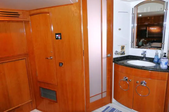 Slide: The Image of 2001 Carver 530 Voyager Pilothouse bathroom with wooden cabinetry and modern fixtures. - 16