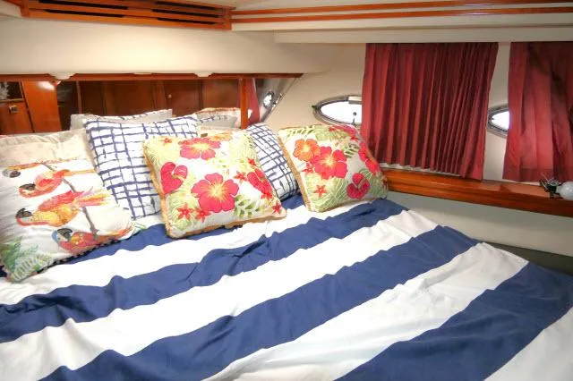 Slide: The Image of Cozy bedroom in 2001 Carver 530 Voyager Pilothouse with floral pillows and striped bedding. - 25