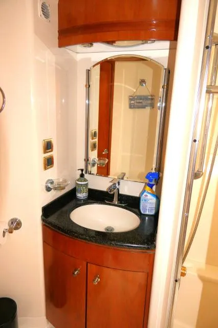 Slide: The Image of 2001 Carver 530 Voyager Pilothouse bathroom with sink, mirror, and storage cabinet. - 30
