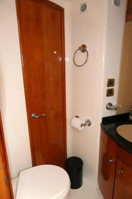 Slide: The Image of 2001 Carver 530 Voyager Pilothouse bathroom with wooden door and modern fixtures. - 31