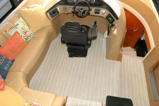Slide: The Image of 2001 Carver 530 Voyager Pilothouse interior helm with seating and control panel. - 32