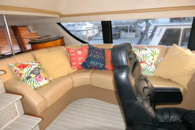 Slide: The Image of Interior of 2001 Carver 530 Voyager Pilothouse with cozy seating and colorful pillows. - 34