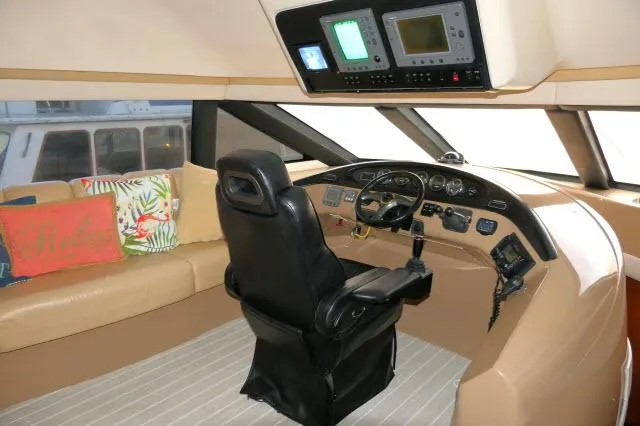 Slide: The Image of 2001 Carver 530 Voyager Pilothouse interior with captain's chair and navigation equipment. - 35