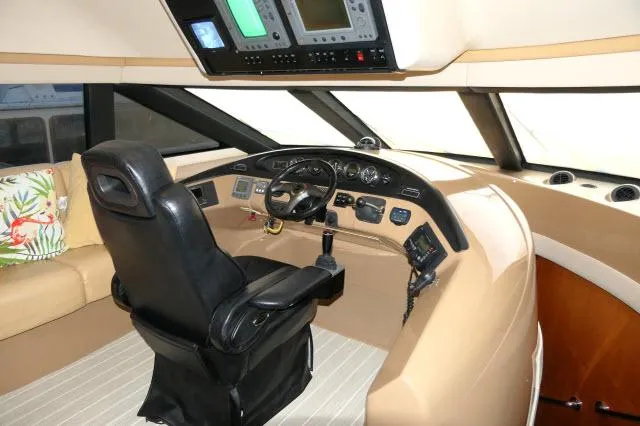 Slide: The Image of 2001 Carver 530 Voyager Pilothouse helm with captain's chair and navigation instruments. - 36