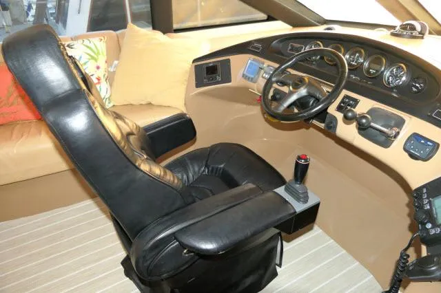 Slide: The Image of 2001 Carver 530 Voyager Pilothouse helm with black captain's chair and control panel. - 37
