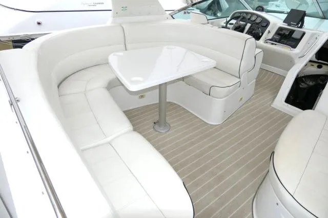 Slide: The Image of 2001 Carver 530 Voyager Pilothouse interior with white seating and table. - 39