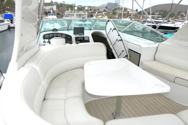 Slide: The Image of 2001 Carver 530 Voyager Pilothouse yacht interior with white seating and table. - 40