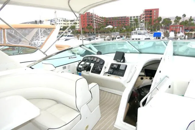 Slide: The Image of 2001 Carver 530 Voyager Pilothouse yacht interior with helm station and marina view. - 41