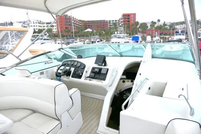 Slide: The Image of 2001 Carver 530 Voyager Pilothouse yacht interior with helm station and marina background. - 42
