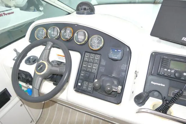Slide: The Image of 2001 Carver 530 Voyager Pilothouse helm with steering wheel, gauges, and navigation controls. - 43