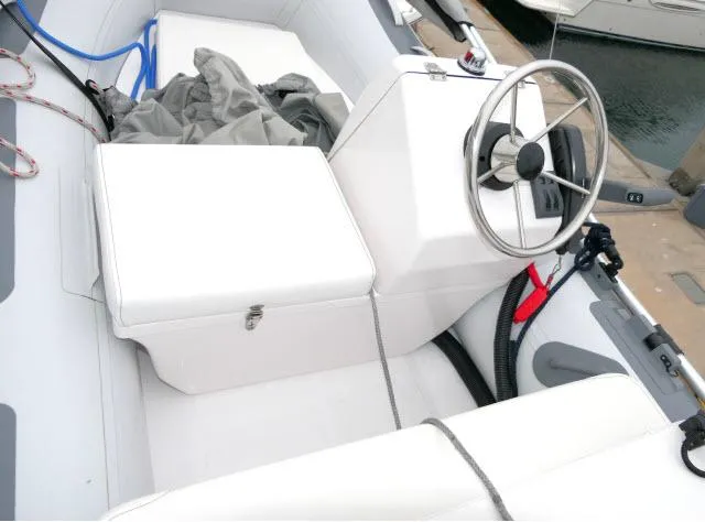 Slide: The Image of 2001 Carver 530 Voyager Pilothouse boat interior with steering wheel and seating. - 47