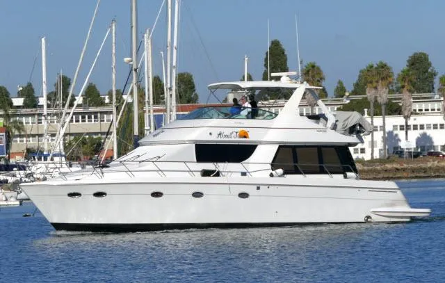 Slide: The Image of 2001 Carver 530 Voyager Pilothouse yacht cruising in a marina. - 68