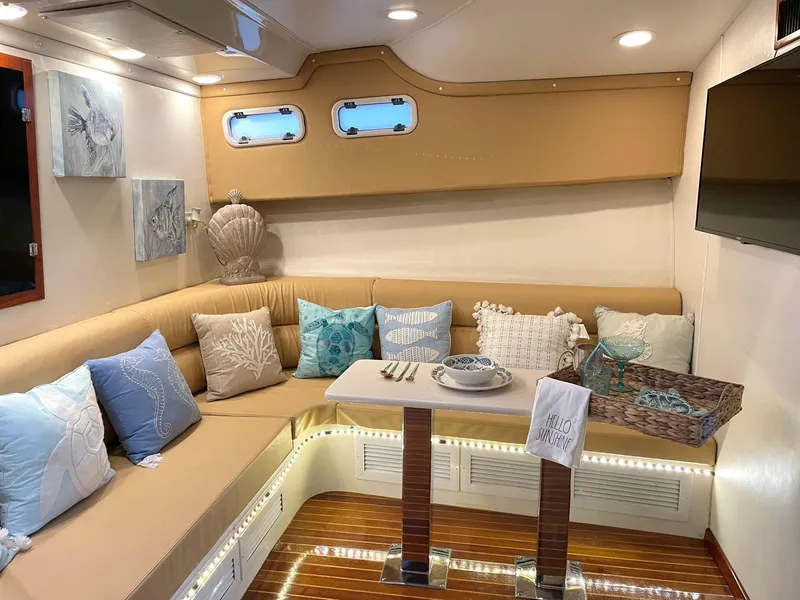 Slide: The Image of Luxurious interior of a 2003 Cabo 45 Express yacht with cozy seating and elegant decor. - 12