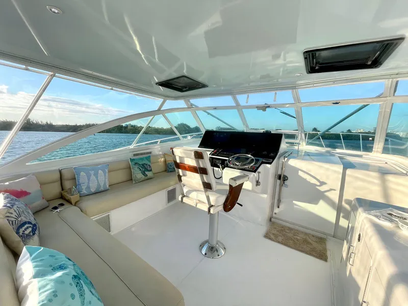Slide: The Image of Interior of 2003 Cabo 45 Express yacht with helm and seating area. - 13