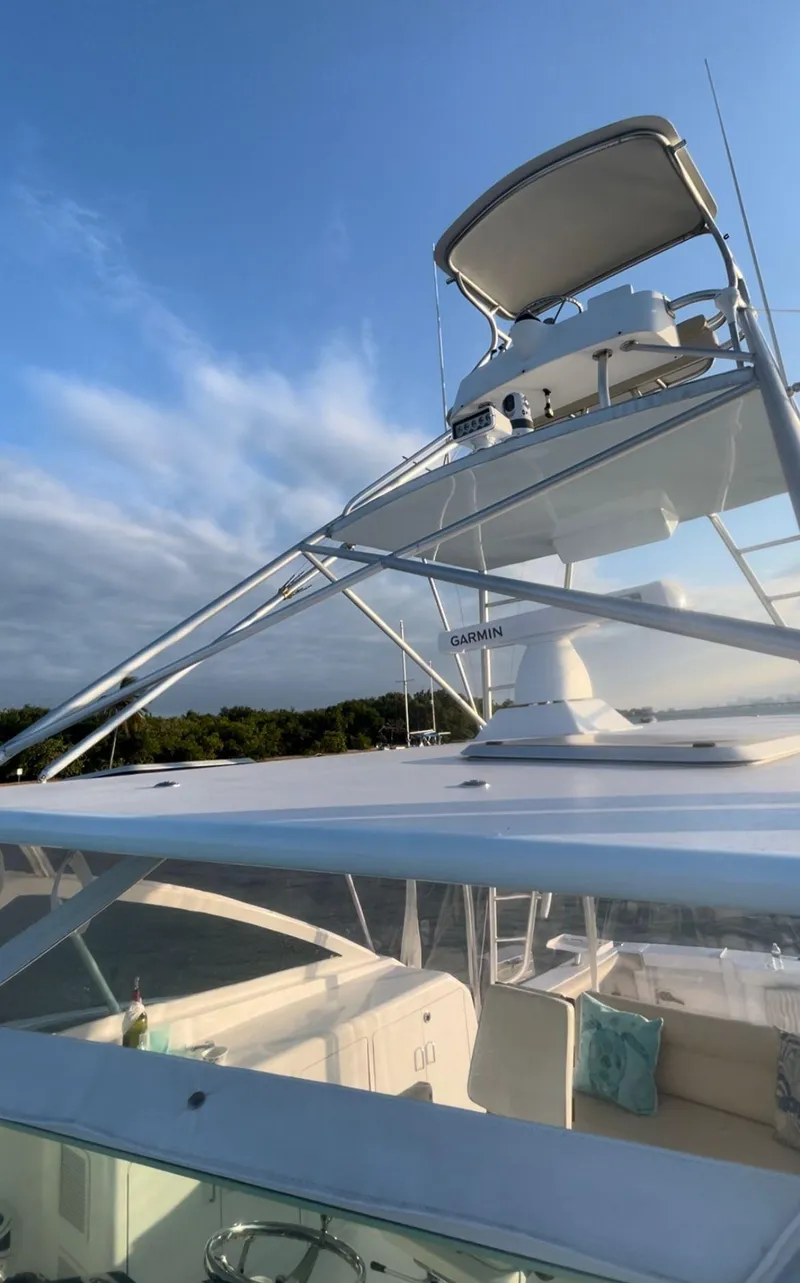 Slide: The Image of 2003 Cabo 45 Express boat with flybridge under a clear sky. - 18