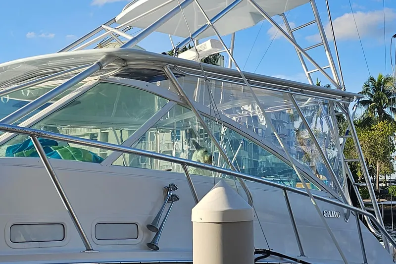 Slide: The Image of 2003 Cabo 45 Express boat docked with clear blue sky background. - 4