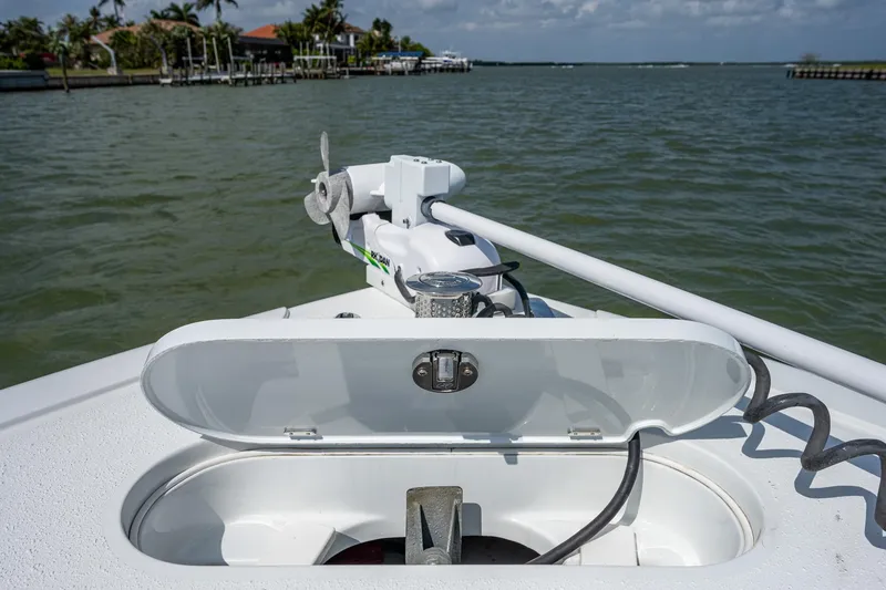 Slide: The Image of 2015 Yellowfin 32 boat anchor compartment with open lid, view of water and shoreline. - 15