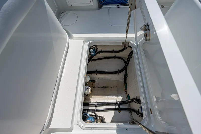 Slide: The Image of Open hatch of a 2015 Yellowfin 32 boat showing internal wiring and plumbing. - 24