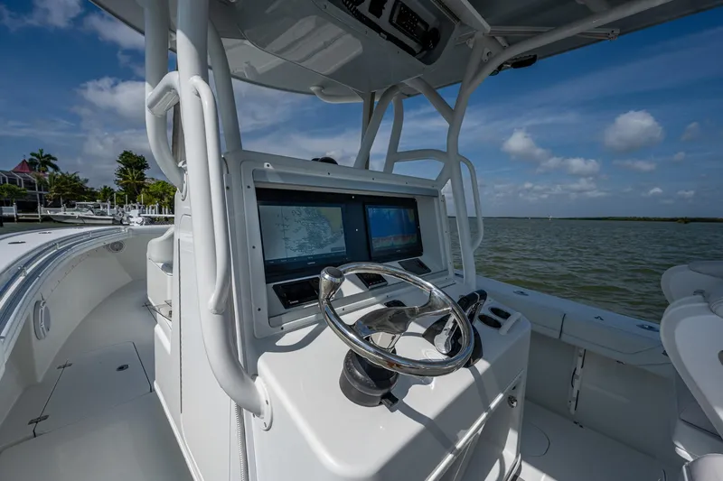 Slide: The Image of 2015 Yellowfin 32 boat helm with dual navigation screens on a sunny day. - 28