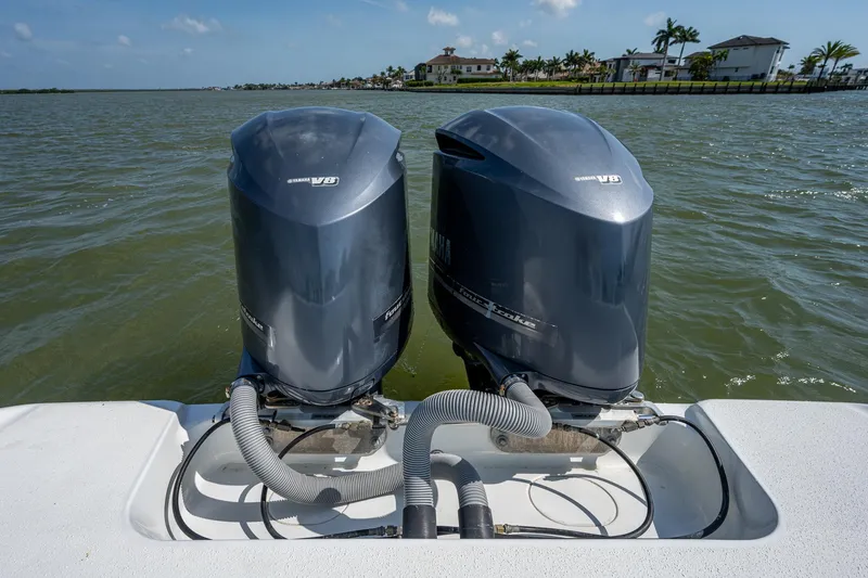 Slide: The Image of Twin outboard motors on a 2015 Yellowfin 32 boat in a coastal setting. - 33