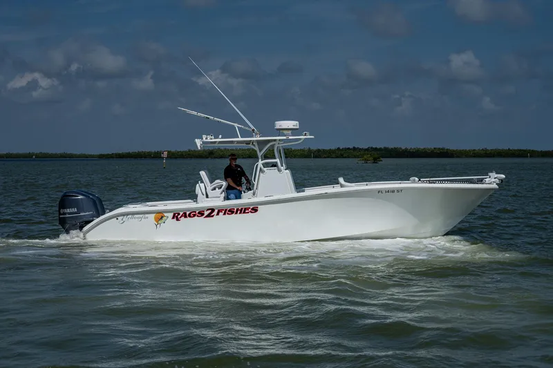 Slide: The Image of 2015 Yellowfin 32 boat cruising on water with Rags 2 Fishes decal. - 4