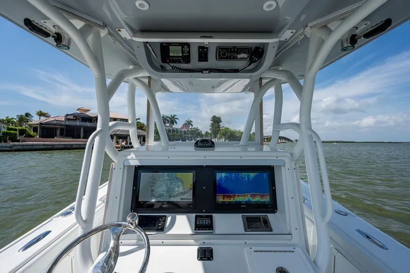 Slide: The Image of 2015 Yellowfin 32 boat dashboard with navigation screens on a sunny day. - 7