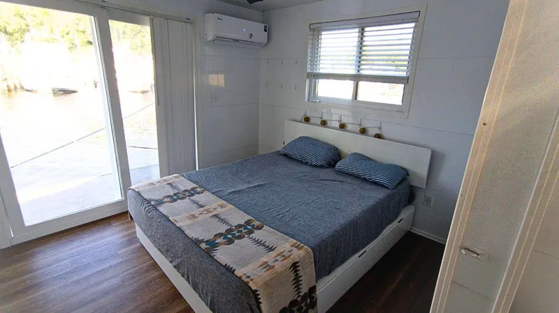 Slide: The Image of Modern bedroom interior on 2022 Houseboat 36' A&M Manufacturing, featuring a cozy bed and scenic view. - 12