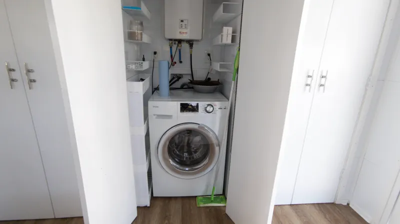 Slide: The Image of Compact laundry area on 2022 Houseboat 36' A&M Manufacturing. - 14