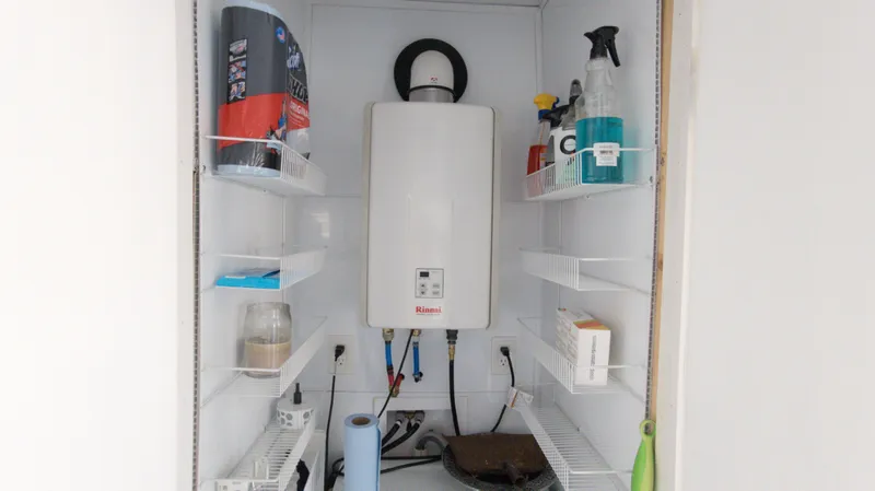 Slide: The Image of Houseboat utility closet with Rinnai water heater and storage shelves, 2022 model. - 15