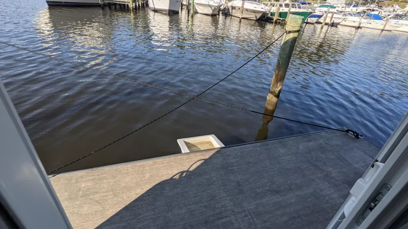 Slide: The Image of Houseboat docked at marina, 2022 A&M Manufacturing 36' model, calm water view. - 17